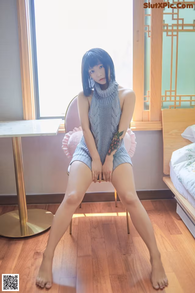 A woman sitting on a chair in a room.