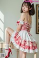 a woman in a red and white dress sitting on a table