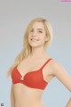 A woman in a red bra posing for a picture.