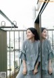 A couple of women standing next to each other on a balcony.