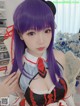 A woman with purple hair wearing a maid outfit.