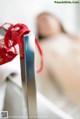 A close up of a red ribbon tied to a metal pole.